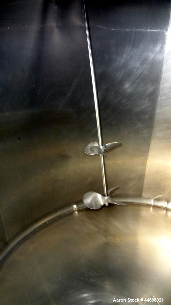 Used Mueller Tank, 1000 Gallon, 316 Stainless Steel, Vertical. Approximate 76” diameter x 57” straight side, open top with (2) covers, sloped bottom. (2) Lightnin clamp on agitators. (1) Model XJ-65V...