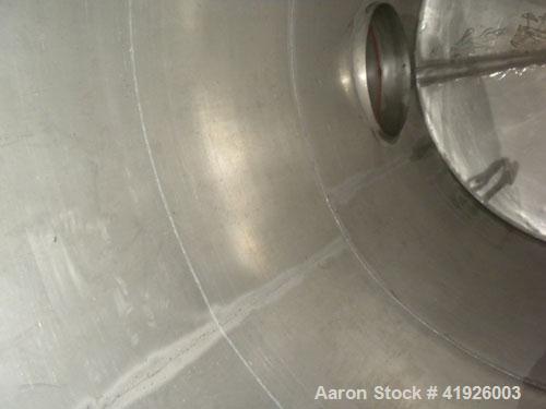 Used Tank, 2800 Gallon, 316 Stainless Steel, Vertical. 84" diameter x 116" straight side, slight cone top, coned bottom. Openings: top (2) 3"; side 24" manway with bolt on cover; 3-1/2" NPT center bo...