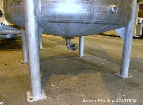 Used Tank, 1075 Gallon, 304 Stainless Steel, Vertical. 72" Diameter x 60" straight side, dished top and bottom. Off center top entering agitator, approximate 1-1/2" diameter shaft with a 3 blade turb...