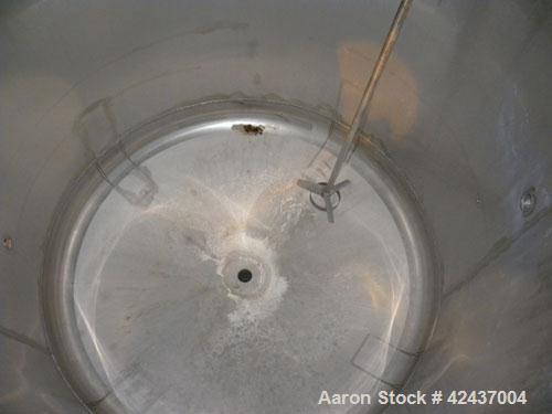 Used Tank, 1075 Gallon, 304 Stainless Steel, Vertical. 72" Diameter x 60" straight side, dished top and bottom. Off center top entering agitator, approximate 1-1/2" diameter shaft with a 3 blade turb...