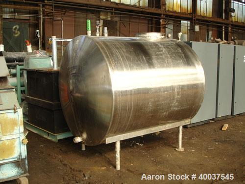 Used- Tank, 1200 gallon, stainless steel, horizontal. Approximately 66" diameter x 72" straight side, dished ends. Top manwa...