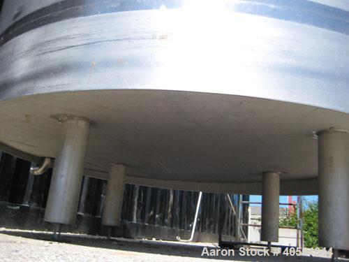 Used 1,800 gallon vertical slope bottom stainless steel tank, 7 ft diameter x 6.3 ft straight height, dished top on legs with side entry manway with swing door cover.