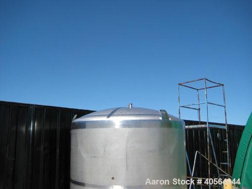 Used 1,800 gallon vertical slope bottom stainless steel tank, 7 ft diameter x 6.3 ft straight height, dished top on legs with side entry manway with swing door cover.
