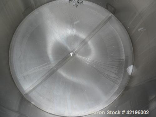 Used Indian Tuff-Tank Tank, 1480 Gallon, 316 Stainless Steel. 72" diameter x 84" straight side, flat top with hinged cover and slight cone bottom. Provision for a clamp on agitator. 2 1/2" NPT center...