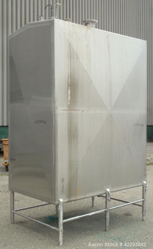 Used Rectangular Tank, 1500 Gallon, 316 Stainless Steel, Vertical. Approximately 76" long x 48" wide x 94" tall. Gabled top, flat bottom. Openings: top (2) 1-1/2" NPT, 3-1/2" threaded, (2) 2" tri-cla...