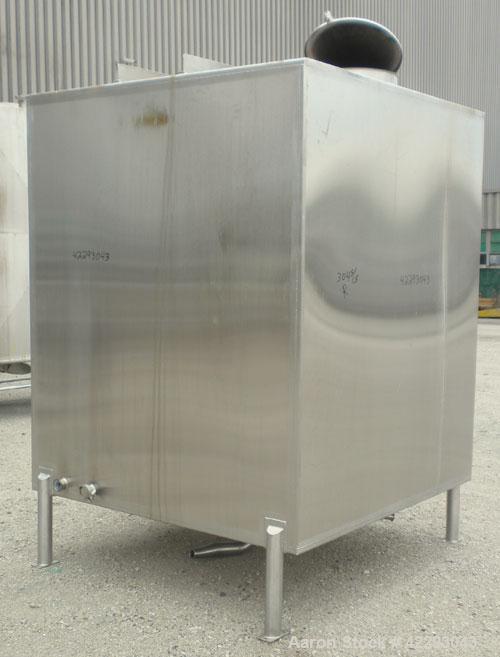 Used Square Tank, 1400 Gallon, 304 stainless steel, vertical. Approximately 66" long x 66" wide x 76" tall. Flat top and bottom. Openings: top 1" tri-clamp, 1-1/2" tri-clamp, 2" tri-clamp, (3) 3" tri...