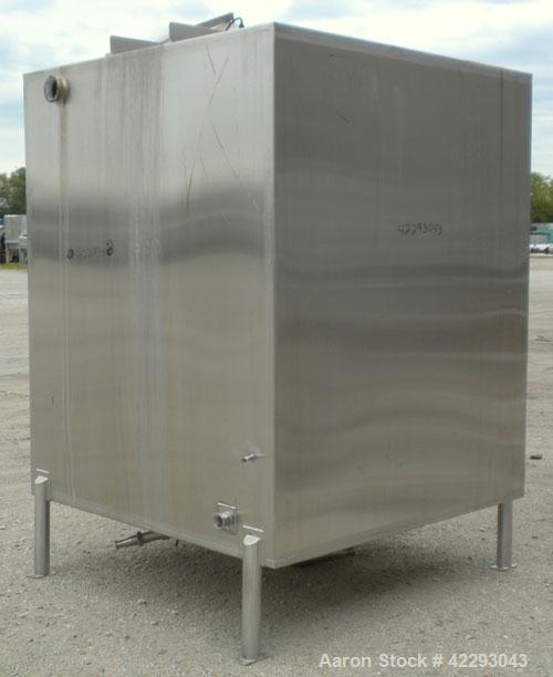 Used Square Tank, 1400 Gallon, 304 stainless steel, vertical. Approximately 66" long x 66" wide x 76" tall. Flat top and bottom. Openings: top 1" tri-clamp, 1-1/2" tri-clamp, 2" tri-clamp, (3) 3" tri...