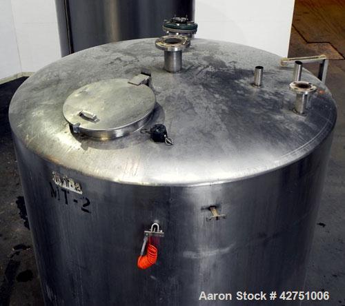 Used Tank, 2000 Gallon, Stainless Steel, Vertical. 84" Diameter x 80" straight side. Dished top, coned bottom. Off center top entering Lightnin agitator, model XJC-117. 1-1/2" Diameter shaft with (2)...