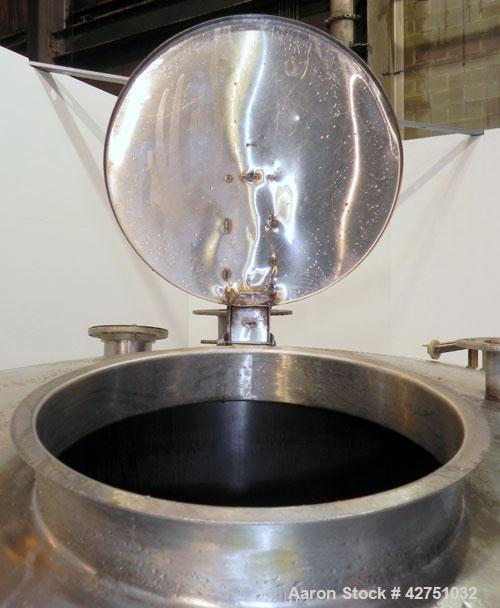 Used Tank, 2000 Gallon, 304 Stainless Steel Vertical. 84" Diameter x 80" straight side. Dished top, coned bottom. Openings top (2) 2", 4", 6", 18" man way with cover, side 2". 3" Threaded center bott...