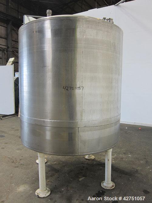 Used Tank, 1000 Gallon, 304 Stainless Steel, Vertical. 66" Diameter x 66" straight side, dished top, coned bottom. Openings top 1-1/2", (2) 2" NPT, (2) 3", 18" man way with cover. 2" Tri-clamp center...