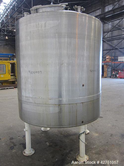 Used Tank, 1000 Gallon, 304 Stainless Steel, Vertical. 66" Diameter x 66" straight side, dished top, coned bottom. Openings top 1-1/2", (2) 2" NPT, (2) 3", 18" man way with cover. 2" Tri-clamp center...