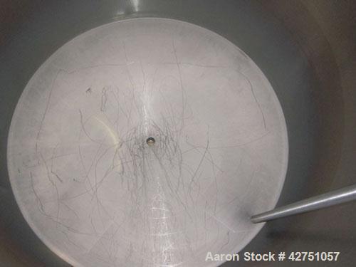 Used Tank, 1000 Gallon, 304 Stainless Steel, Vertical. 66" Diameter x 66" straight side, dished top, coned bottom. Openings top 1-1/2", (2) 2" NPT, (2) 3", 18" man way with cover. 2" Tri-clamp center...