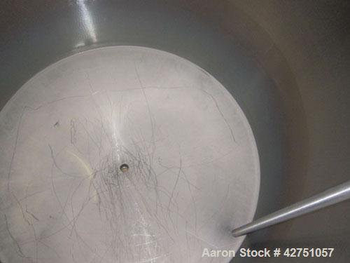 Used Tank, 1000 Gallon, 304 Stainless Steel, Vertical. 66" Diameter x 66" straight side, dished top, coned bottom. Openings top 1-1/2", (2) 2" NPT, (2) 3", 18" man way with cover. 2" Tri-clamp center...