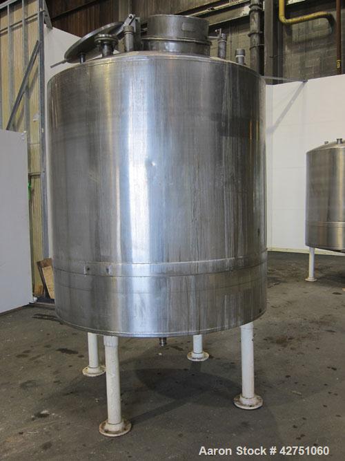 Used Tank, 1000 Gallon, 304 Stainless Steel, Vertical. 66" Diameter x 66" straight side, dished top, coned bottom. Off center top entering Lightnin agitator, model N33G-75, 1-1/2" diameter shaft with...