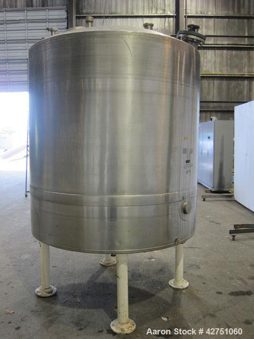Used Tank, 1000 Gallon, 304 Stainless Steel, Vertical. 66" Diameter x 66" straight side, dished top, coned bottom. Off center top entering Lightnin agitator, model N33G-75, 1-1/2" diameter shaft with...