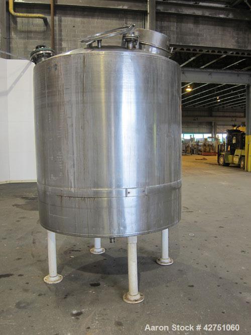 Used Tank, 1000 Gallon, 304 Stainless Steel, Vertical. 66" Diameter x 66" straight side, dished top, coned bottom. Off center top entering Lightnin agitator, model N33G-75, 1-1/2" diameter shaft with...