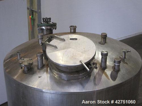 Used Tank, 1000 Gallon, 304 Stainless Steel, Vertical. 66" Diameter x 66" straight side, dished top, coned bottom. Off center top entering Lightnin agitator, model N33G-75, 1-1/2" diameter shaft with...
