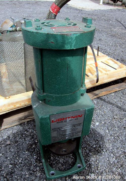 Used Tank, 1000 Gallon, 304 Stainless Steel, Vertical. 66" Diameter x 66" straight side, dished top, coned bottom. Off center top entering Lightnin agitator, model N33G-75, 1-1/2" diameter shaft with...