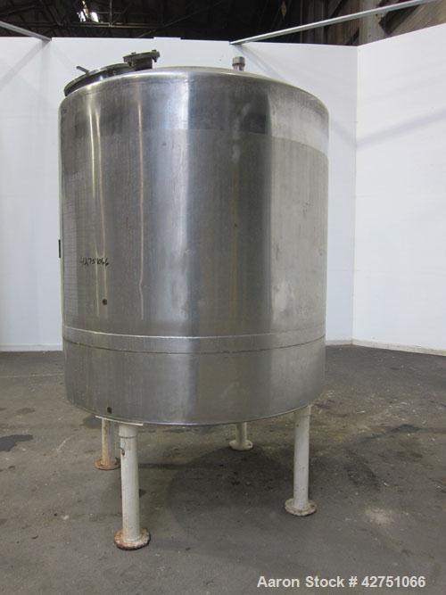 Used Tank, 1000 Gallon, 304 Stainless Steel, Vertical. 66" Diameter x 66" straight side, dished top, coned bottom. Openings top 1-1/2", (2) 2" NPT, (2) 3", 18" man way with cover. 2" Tri-clamp center...