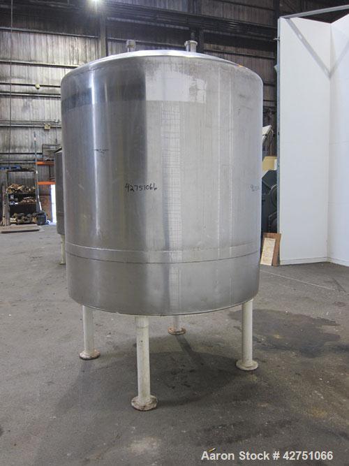 Used Tank, 1000 Gallon, 304 Stainless Steel, Vertical. 66" Diameter x 66" straight side, dished top, coned bottom. Openings top 1-1/2", (2) 2" NPT, (2) 3", 18" man way with cover. 2" Tri-clamp center...