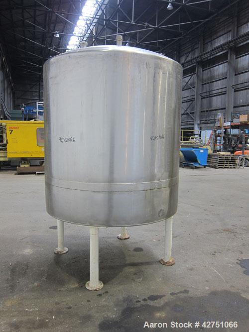 Used Tank, 1000 Gallon, 304 Stainless Steel, Vertical. 66" Diameter x 66" straight side, dished top, coned bottom. Openings top 1-1/2", (2) 2" NPT, (2) 3", 18" man way with cover. 2" Tri-clamp center...