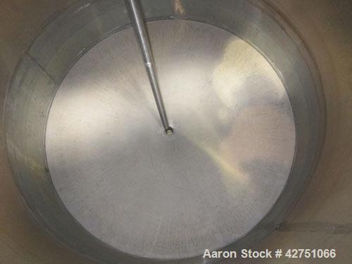 Used Tank, 1000 Gallon, 304 Stainless Steel, Vertical. 66" Diameter x 66" straight side, dished top, coned bottom. Openings top 1-1/2", (2) 2" NPT, (2) 3", 18" man way with cover. 2" Tri-clamp center...