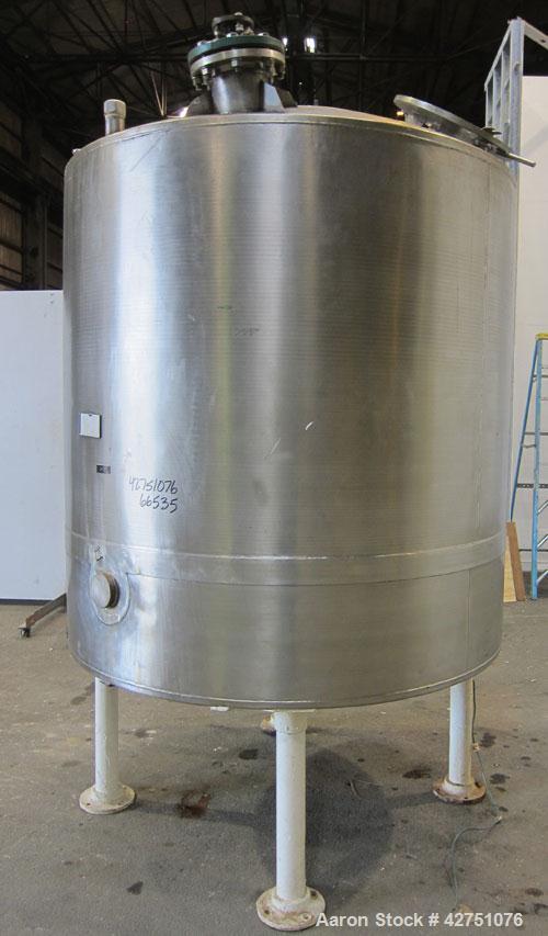 Used Tank, 1000 Gallon, 304 Stainless Steel, Vertical. 66" Diameter x 66" straight side, dished top, coned bottom. Off center top entering Lightnin agitator, Model N33G-75, 1-1/2" diameter shaft with...