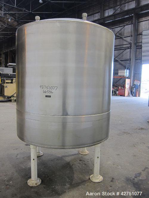 Used Tank, 1000 Gallon, 304 Stainless Steel, Vertical. 66" Diameter x 66" straight side, dished top, coned bottom. Openings top 1-1/2", (2) 2" NPT, (2) 3", 18" man way with cover. 2" Tri-clamp center...