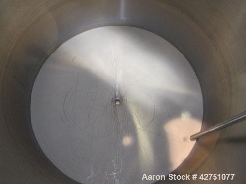Used Tank, 1000 Gallon, 304 Stainless Steel, Vertical. 66" Diameter x 66" straight side, dished top, coned bottom. Openings top 1-1/2", (2) 2" NPT, (2) 3", 18" man way with cover. 2" Tri-clamp center...