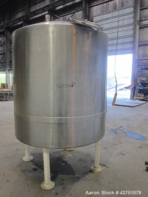 Used Tank, 1000 Gallon, 304 Stainless Steel, Vertical. 66" Diameter x 66" straight side, dished top, coned bottom. Openings top 1-1/2", (2) 2" NPT, (2) 3", 18" man way with cover. 2" Tri-clamp center...