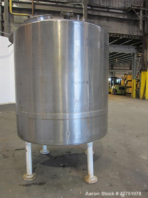 Used Tank, 1000 Gallon, 304 Stainless Steel, Vertical. 66" Diameter x 66" straight side, dished top, coned bottom. Openings top 1-1/2", (2) 2" NPT, (2) 3", 18" man way with cover. 2" Tri-clamp center...