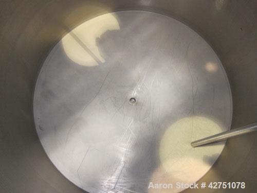 Used Tank, 1000 Gallon, 304 Stainless Steel, Vertical. 66" Diameter x 66" straight side, dished top, coned bottom. Openings top 1-1/2", (2) 2" NPT, (2) 3", 18" man way with cover. 2" Tri-clamp center...