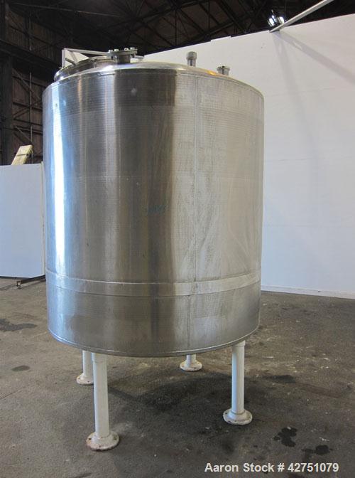 Used Tank, 1000 Gallon, 304 Stainless Steel, Vertical. 66" Diameter x 66" straight side, dished top, coned bottom. Openings top 1-1/2", (2) 2" NPT, (2) 3", 18" man way with cover. 2" Tri-clamp center...