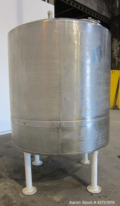 Used Tank, 1000 Gallon, 304 Stainless Steel, Vertical. 66" Diameter x 66" straight side, dished top, coned bottom. Openings top 1-1/2", (2) 2" NPT, (2) 3", 18" man way with cover. 2" Tri-clamp center...