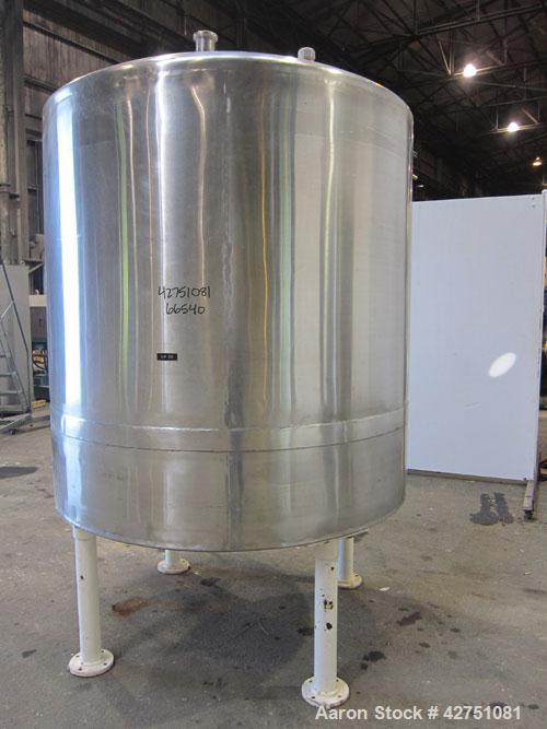 Used Tank, 1000 Gallon, 304 Stainless Steel, Vertical. 66" Diameter x 66" straight side, dished top, coned bottom. Openings top 1-1/2", (2) 2" NPT, (2) 3", 18" man way with cover. 2" Tri-clamp center...