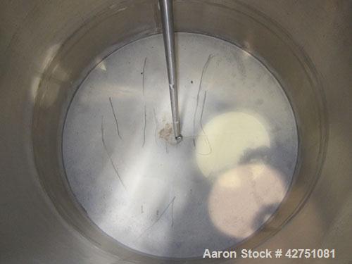 Used Tank, 1000 Gallon, 304 Stainless Steel, Vertical. 66" Diameter x 66" straight side, dished top, coned bottom. Openings top 1-1/2", (2) 2" NPT, (2) 3", 18" man way with cover. 2" Tri-clamp center...