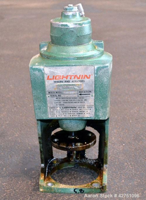 Used Tank, 2000 Gallon, 304 Stainless Steel Vertical. 84” Diameter x 80” straight side. Dished top, coned bottom. Off center top entering Lightnin air operated agitator, model N33AG-100. 1-1/2” Diame...