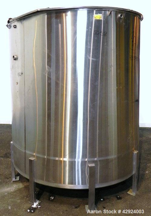 Used Tank, 1000 Gallon, 316 Stainless Steel, Vertical. Approximate 68’’ diameter x 70’’ straight side. Open top with a 1 piece hinged cover, flat bottom. Approximate 2’’ center bottom outlet. Mounted...
