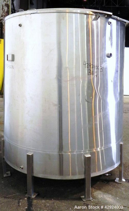 Used Tank, 1000 Gallon, 316 Stainless Steel, Vertical. Approximate 68’’ diameter x 70’’ straight side. Open top with a 1 piece hinged cover, flat bottom. Approximate 2’’ center bottom outlet. Mounted...