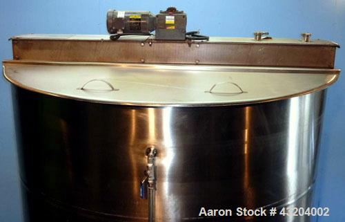 Used Tank, 1,200 Gallon, Stainless Steel, Vertical. Open top with lids, dished bottom. Side mounted level gauge and bridge mounted 1 hp agitator.  1-1/2’’ Center bottom outlet.  Mounted on (4) stainl...
