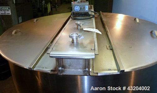 Used Tank, 1,200 Gallon, Stainless Steel, Vertical. Open top with lids, dished bottom. Side mounted level gauge and bridge mounted 1 hp agitator.  1-1/2’’ Center bottom outlet.  Mounted on (4) stainl...