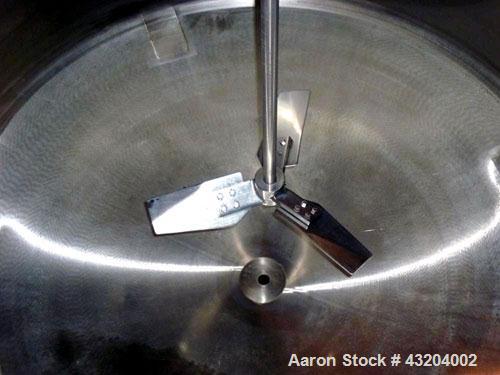 Used Tank, 1,200 Gallon, Stainless Steel, Vertical. Open top with lids, dished bottom. Side mounted level gauge and bridge mounted 1 hp agitator.  1-1/2’’ Center bottom outlet.  Mounted on (4) stainl...