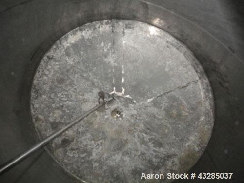 Used Tank, 3000 Gallon, Stainless Steel, Vertical.  Approximately 102" diameter x 84" straight side.  Flat top and bottom.  Off center top entering Lightnin agitator with shaft and prop. Mounted on 4...
