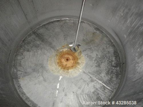 Used Tank, 3000 Gallon, Stainless Steel, Vertical.  Approximately 102" diameter x 84" straight side.  Flat top and bottom.  Off center top entering Lightnin agitator with shaft and prop. Mounted on 4...