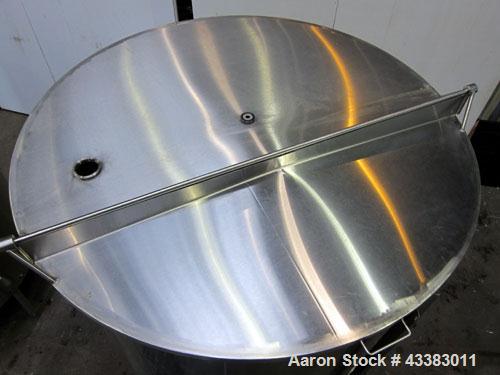 Used Tank, 1000 Gallon, 304 Stainless Steel, Vertical. Approximate 61” diameter x 81” straight side, flat top with a bolt on cover with a 1/3 hinged opening, sloped bottom. Side bottom entering agita...