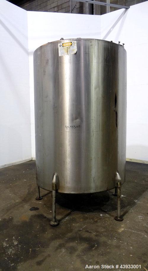 Used Tank, 1050 Gallons, 304 Stainless Steel, Vertical.  Approximately 62” diameter x 82” straight side.  Flat top, sloped bottom.  Off-center top entering Lightnin agitator, model N33G-150.  1-1/2” ...