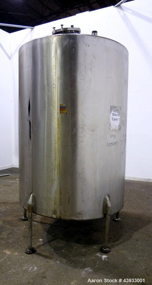 Used Tank, 1050 Gallons, 304 Stainless Steel, Vertical.  Approximately 62” diameter x 82” straight side.  Flat top, sloped bottom.  Off-center top entering Lightnin agitator, model N33G-150.  1-1/2” ...
