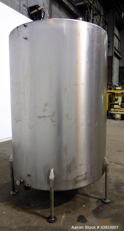 Used Tank, 1050 Gallons, 304 Stainless Steel, Vertical.  Approximately 62” diameter x 82” straight side.  Flat top, sloped bottom.  Off-center top entering Lightnin agitator, model N33G-150.  1-1/2” ...