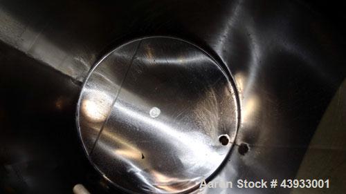 Used Tank, 1050 Gallons, 304 Stainless Steel, Vertical.  Approximately 62” diameter x 82” straight side.  Flat top, sloped bottom.  Off-center top entering Lightnin agitator, model N33G-150.  1-1/2” ...