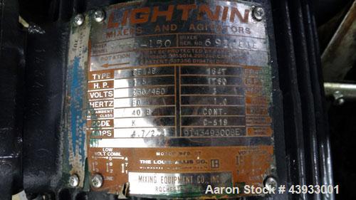 Used Tank, 1050 Gallons, 304 Stainless Steel, Vertical.  Approximately 62” diameter x 82” straight side.  Flat top, sloped bottom.  Off-center top entering Lightnin agitator, model N33G-150.  1-1/2” ...